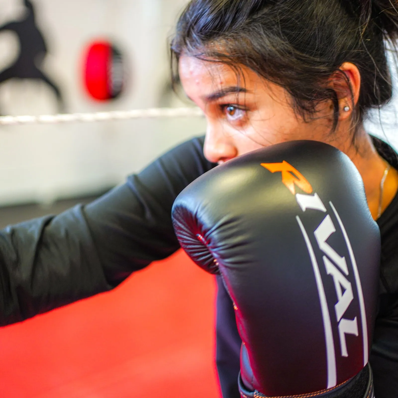A kickboxing student throwing a jab, gloves up