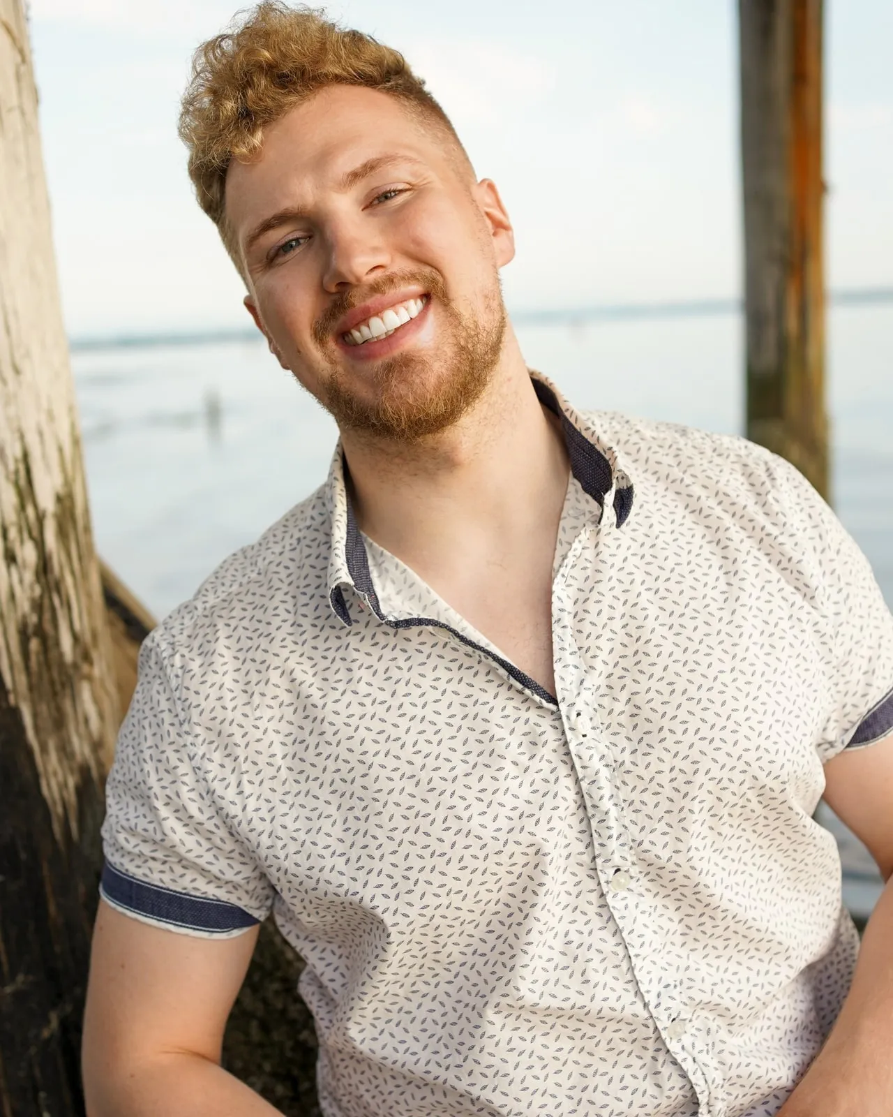 Sensei Troy Parker smiling, in a white patterned shirt by the water